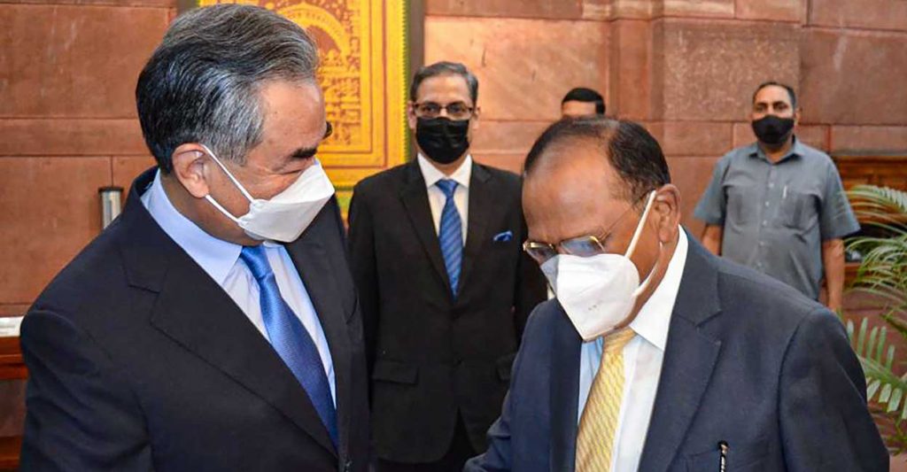 China's Foreign Minister Wang Yi shakes hands with National Security Adviser Ajit Doval, during their meeting, at the South Block, in New Delhi, Friday, March 25, 2022.  PTI