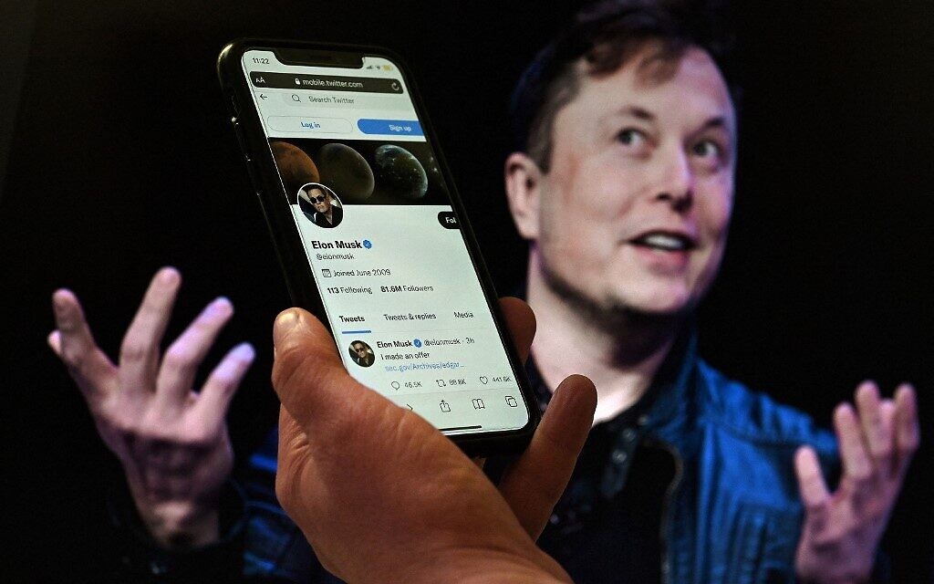(FILES) In this file photo taken on April 14, 2022 In this photo illustration, a phone screen displays the Twitter account of Elon Musk with a photo of him shown in the background, on April 14, 2022, in Washington, DC. - Musk has lined up $46.5 billion in financing for a possible hostile takeover of Twitter and is "exploring" a direct tender offer to shareholders, according to a securities filing released on April 21, 2022. Musk's filing pointed to a $13 billion debt facility from a financing consortium led by Morgan Stanley, a separate $12.5 billion margin loan from the same bank, as well as $21 billion in equity commitments from Musk himself. (Photo by Olivier DOULIERY / AFP)