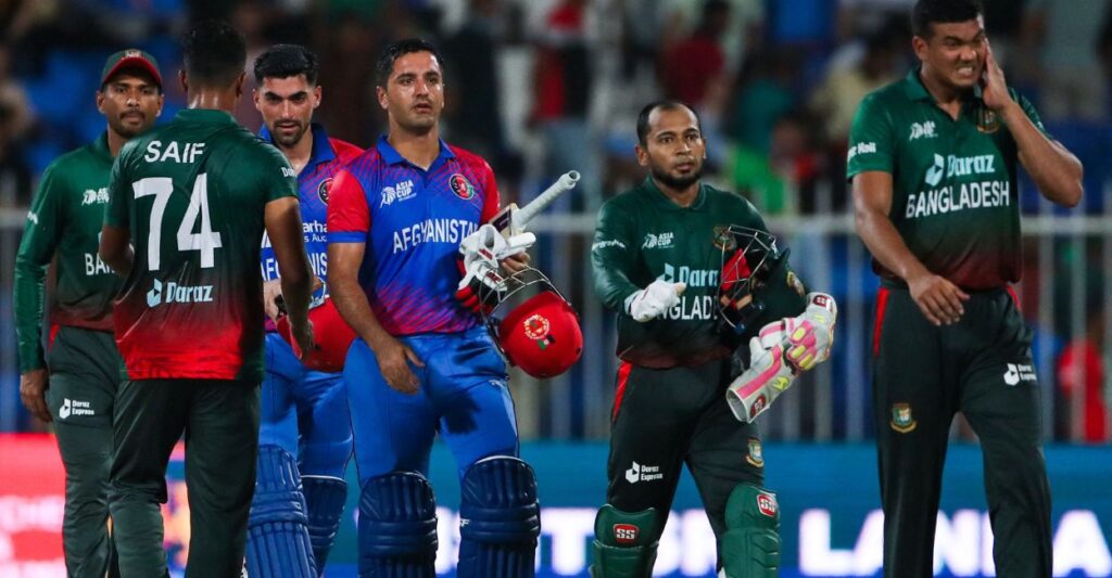 Afghanistan's Najibullah Zadran and teammate Ibrahim Zadran leave with Bangladesh's players after winning the Asia Cup Twenty20 international cricket Group B match between Afghanistan and Bangladesh at the Sharjah Cricket Stadium in Sharjah on August 30, 2022. PHOTO: AFP