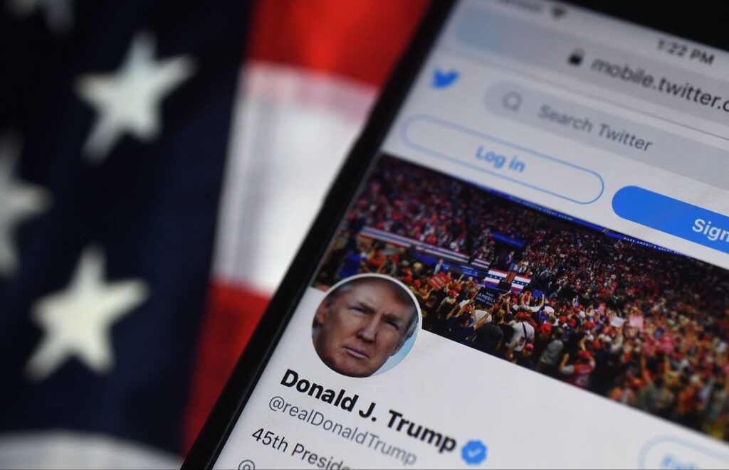 (FILES) In this file photo illustration taken on August 10, 2020, the Twitter account of US President Donald Trump is displayed on a mobile phone in Arlington, Virginia. - Trump's once-blocked Twitter account reappeared on the platform on November 19, 2022, minutes after company owner Elon Musk announced he was lifting the 22-month suspension on the former president over incitement of violence. Trump's account -- dormant since days after the January 6, 2021 riot at the US Capitol by his supporters -- was visible to users after Musk tweeted that "Trump will be reinstated" following a poll on the subject. (Photo by Olivier DOULIERY / AFP)