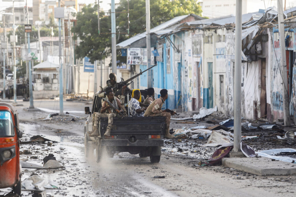 FILE PHOTO: Somali security officers drive past a section of Hotel Hayat, the scene of an al Qaeda-linked al Shabaab group militant attack in Mogadishu, Somalia August 20, 2022. REUTERS/Feisal Omar/File Photo